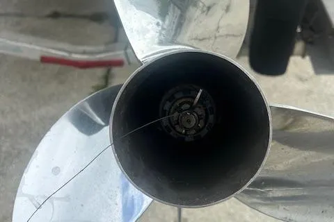  Yacht Photos Pics Close-up of a 2020 Pursuit OS 325 Offshore boat propeller with visible damage.