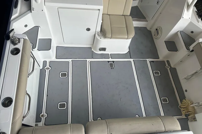  Yacht Photos Pics 2020 Pursuit OS 325 Offshore boat interior with cushioned seating and storage compartments.