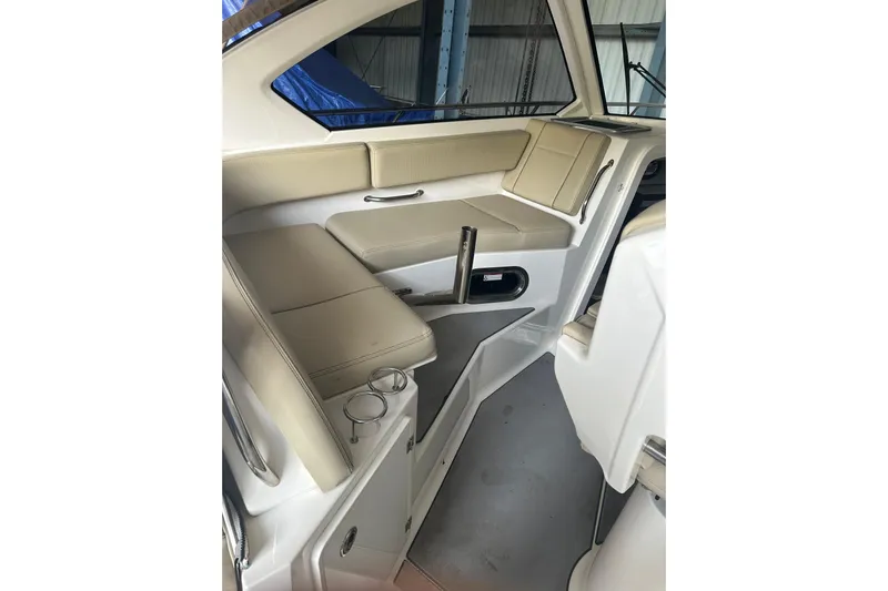  Yacht Photos Pics 2020 Pursuit OS 325 Offshore boat interior with beige seating and cup holders.