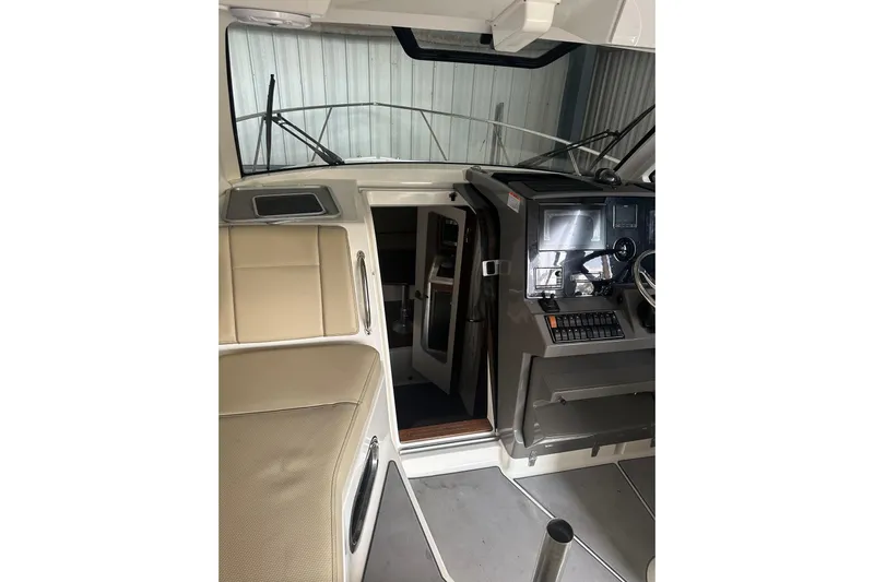  Yacht Photos Pics 2020 Pursuit OS 325 Offshore boat interior with helm and seating area.