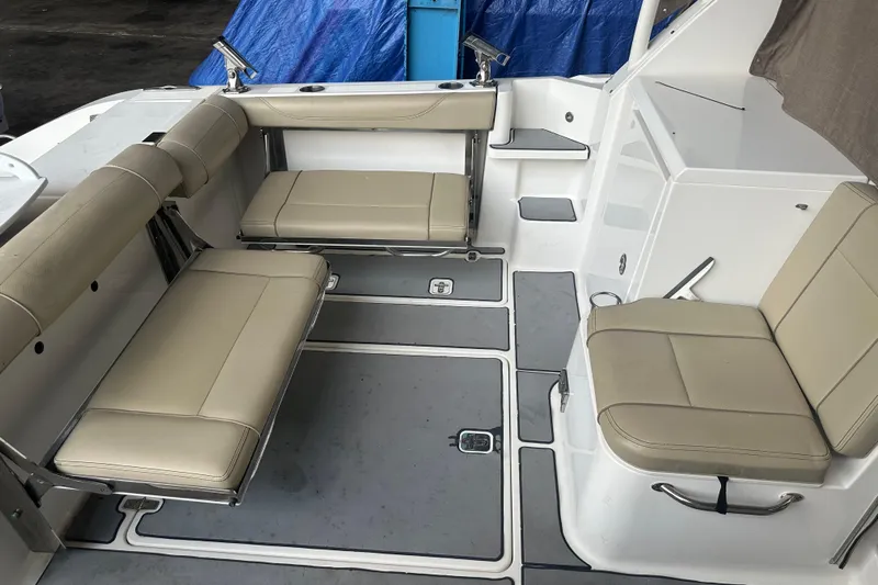  Yacht Photos Pics 2020 Pursuit OS 325 Offshore boat interior with beige seating and gray flooring.