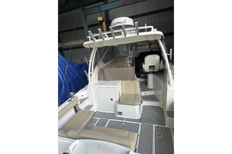  Yacht Photos Pics 2020 Pursuit OS 325 Offshore boat interior with seating and Garmin equipment.