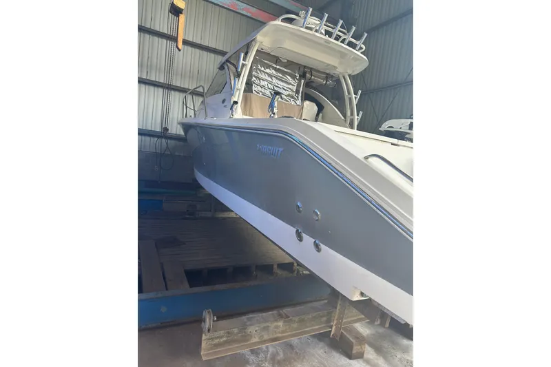  Yacht Photos Pics 2020 Pursuit OS 325 Offshore boat in storage, showcasing sleek design and modern features.