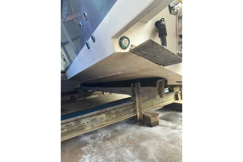  Yacht Photos Pics 2020 Pursuit OS 325 Offshore boat hull on support in storage facility.