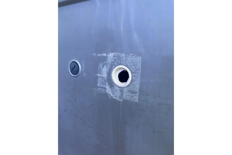  Yacht Photos Pics Hull detail of 2020 Pursuit OS 325 Offshore boat with visible hole and patchwork.