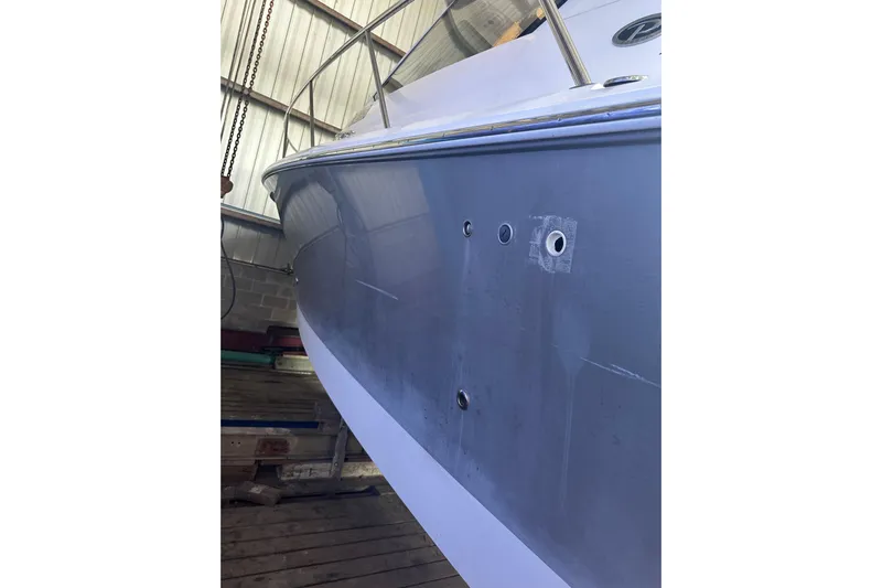  Yacht Photos Pics 2020 Pursuit OS 325 Offshore boat hull in a storage facility.