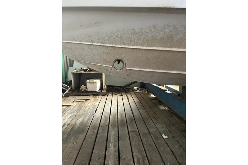  Yacht Photos Pics 2020 Pursuit OS 325 Offshore boat hull on wooden dock, showing underside details.