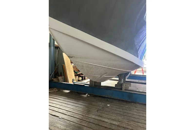  Yacht Photos Pics 2020 Pursuit OS 325 Offshore boat hull on a wooden dock.