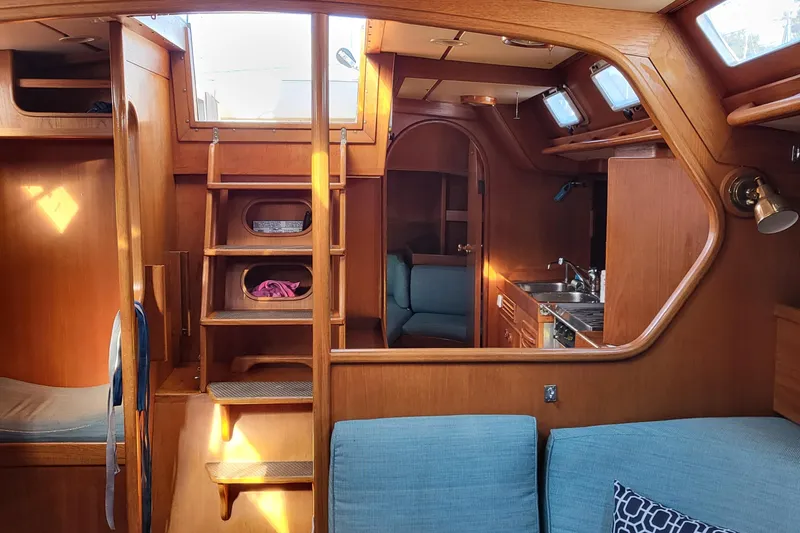 Name Reserved Yacht Photos Pics Interior of 1985 Swan 46 yacht with wooden finish and cozy seating area.