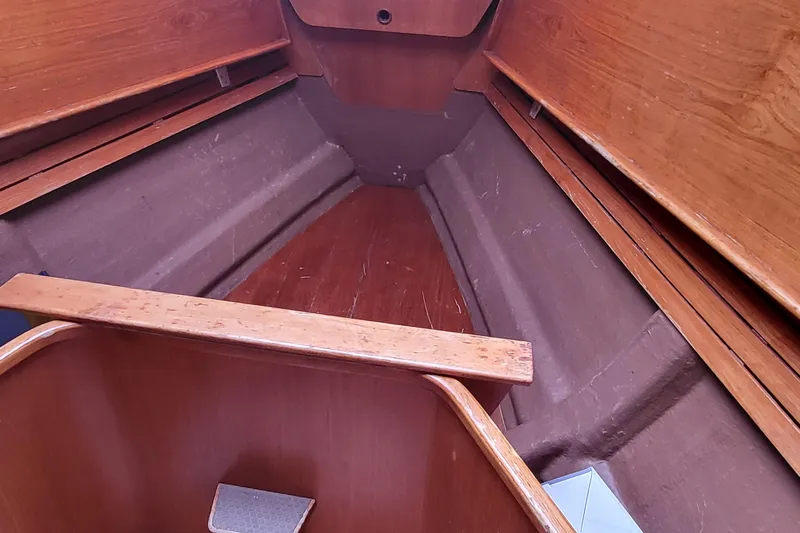 Name Reserved Yacht Photos Pics Interior of 1985 Swan 46 sailboat, featuring wooden paneling and storage compartments.