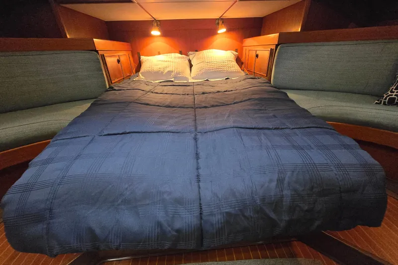 Name Reserved Yacht Photos Pics Luxurious cabin interior of 1985 Swan 46 yacht with cozy bedding and ambient lighting.