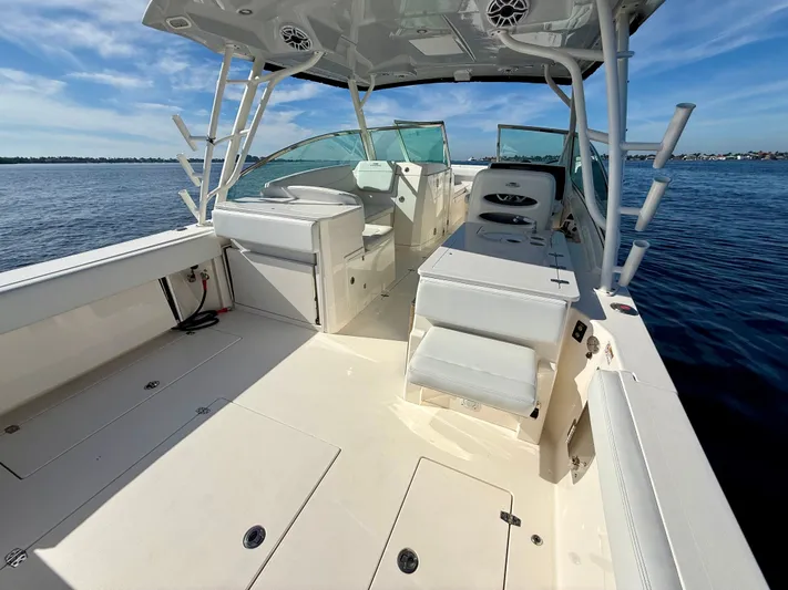  Yacht Photos Pics 2022 Cobia 330 Dual Console boat on calm water.