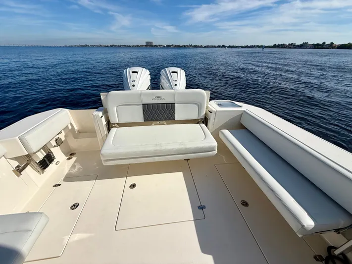  Yacht Photos Pics Cobia 330 Dual Console 2022 on calm water with seating area.