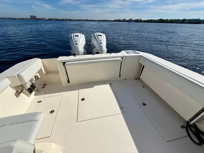  Yacht Photos Pics Cobia 330 Dual Console 2022 on calm water with twin outboard engines.