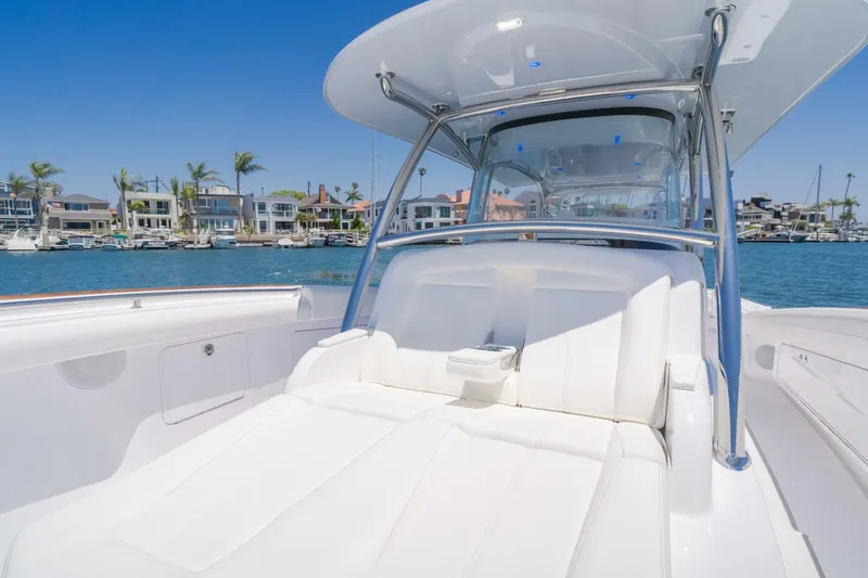  Yacht Photos Pics 2026 Mag Bay 43 Center Console boat with luxurious seating, docked near waterfront homes.
