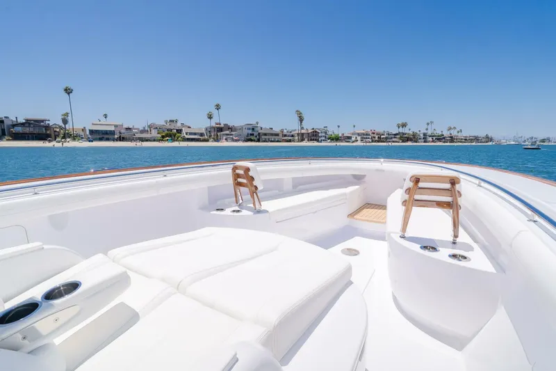  Yacht Photos Pics 2026 Mag Bay 43 Center Console boat with luxurious seating, ocean view, and coastal homes in background.