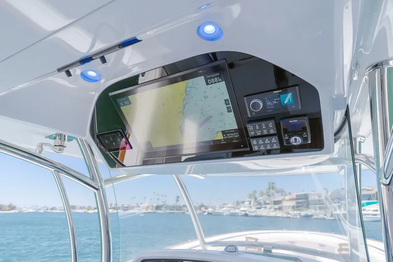  Yacht Photos Pics 2026 Mag Bay 43 Center Console dashboard with navigation and control systems, overlooking marina.