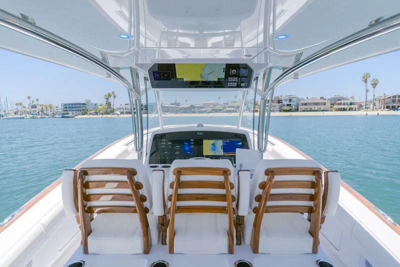  Yacht Photos Pics 2026 Mag Bay 43 Center Console boat interior with wooden chairs and navigation screens.