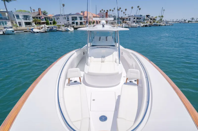  Yacht Photos Pics 2026 Mag Bay 43 Center Console boat on calm water near waterfront homes.