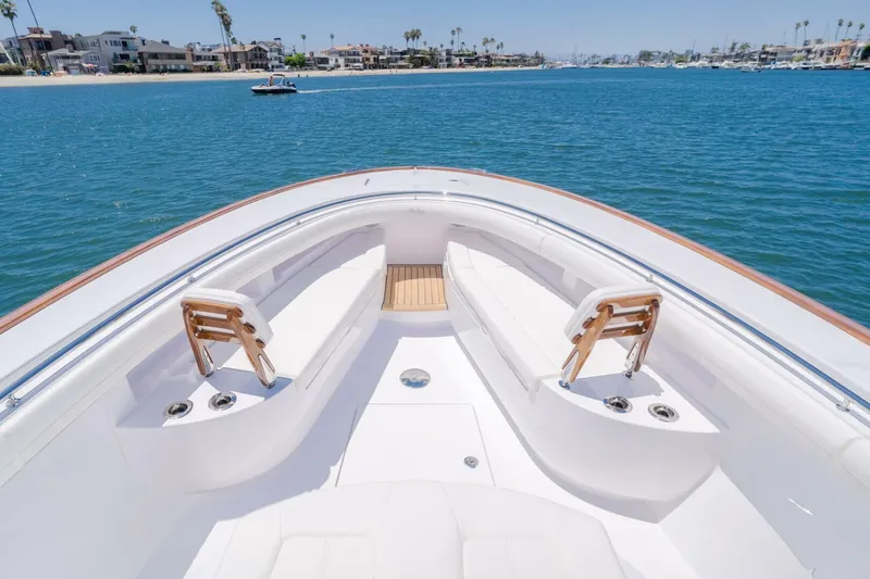  Yacht Photos Pics 2026 Mag Bay 43 Center Console boat on calm water, featuring spacious seating and sleek design.
