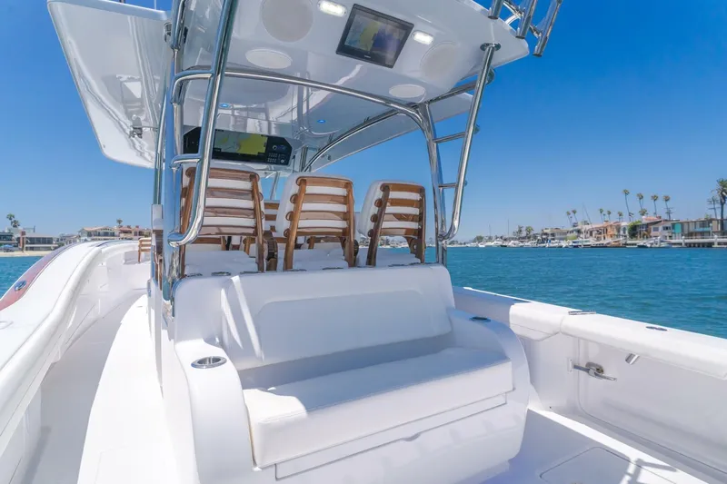  Yacht Photos Pics 2026 Mag Bay 43 Center Console boat on clear blue water, showcasing sleek design and seating.