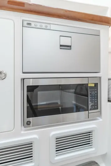  Yacht Photos Pics 2026 Mag Bay 43 Center Console galley with stainless steel appliances.