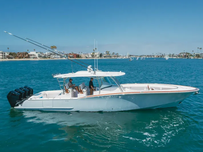  Yacht Photos Pics 2026 Mag Bay 43 Center Console boat cruising on clear blue water.