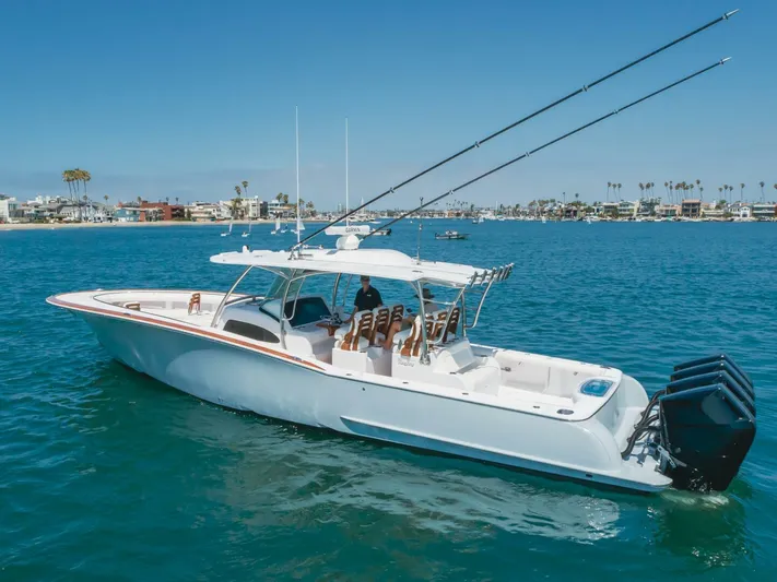  Yacht Photos Pics 2026 Mag Bay 43 Center Console boat cruising on clear blue water.