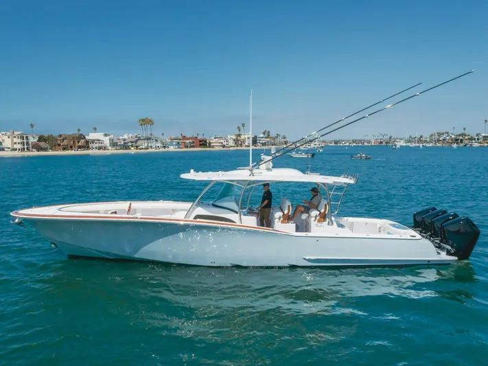  Yacht Photos Pics 2026 Mag Bay 43 Center Console boat cruising on clear blue water.