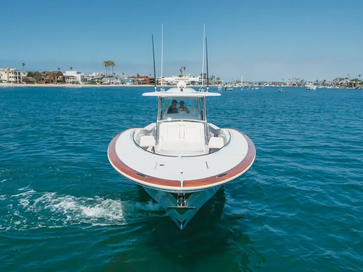  Yacht Photos Pics 2026 Mag Bay 43 Center Console boat cruising on clear blue water.