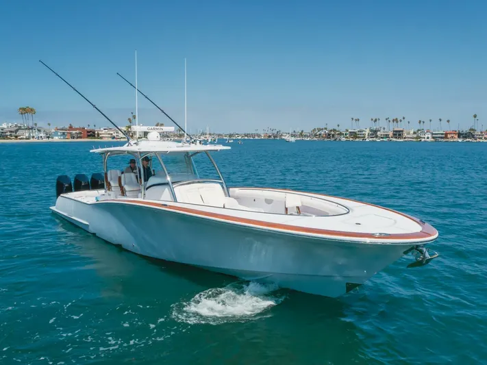  Yacht Photos Pics 2026 Mag Bay 43 Center Console boat cruising on clear blue water.