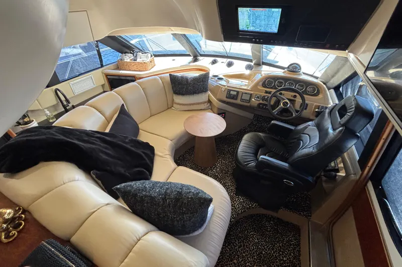 Mr & Mrs Smith Yacht Photos Pics Luxurious interior of 2003 Carver 450 Voyager Pilothouse with plush seating and modern helm.