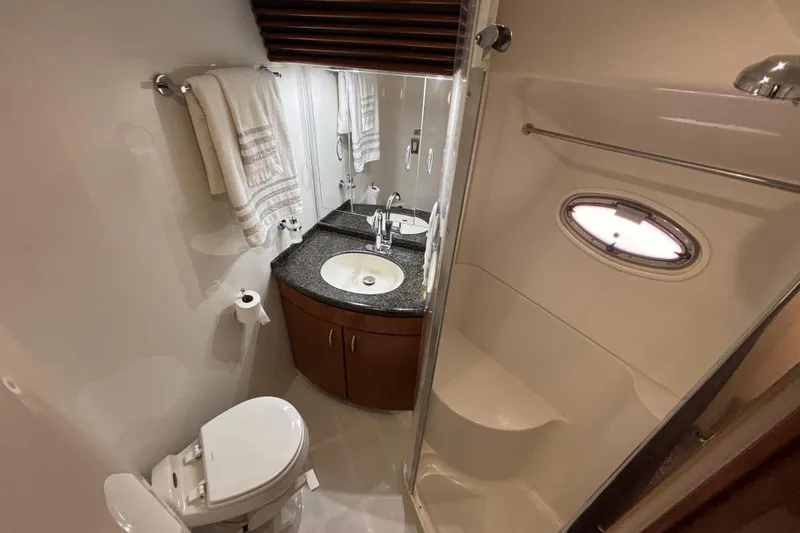 Mr & Mrs Smith Yacht Photos Pics Bathroom interior of 2003 Carver 450 Voyager Pilothouse with sink, toilet, and shower.