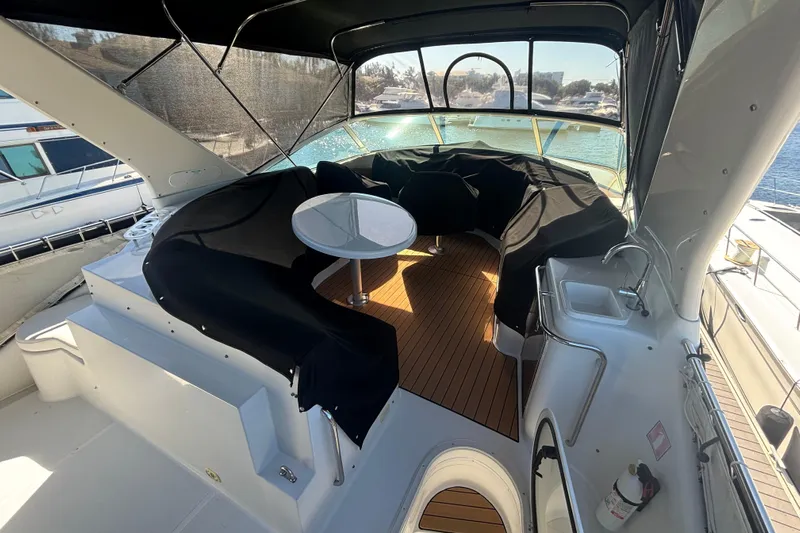 Mr & Mrs Smith Yacht Photos Pics 2003 Carver 450 Voyager Pilothouse yacht interior with seating, table, and sink.