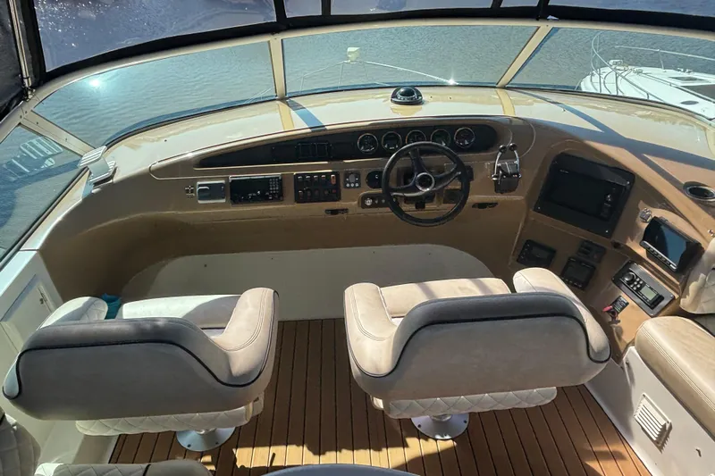Mr & Mrs Smith Yacht Photos Pics Pilothouse interior of 2003 Carver 450 Voyager with dual seats and control panel.