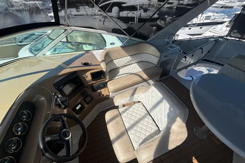 Mr & Mrs Smith Yacht Photos Pics 2003 Carver 450 Voyager Pilothouse interior with helm, seating, and wood flooring.