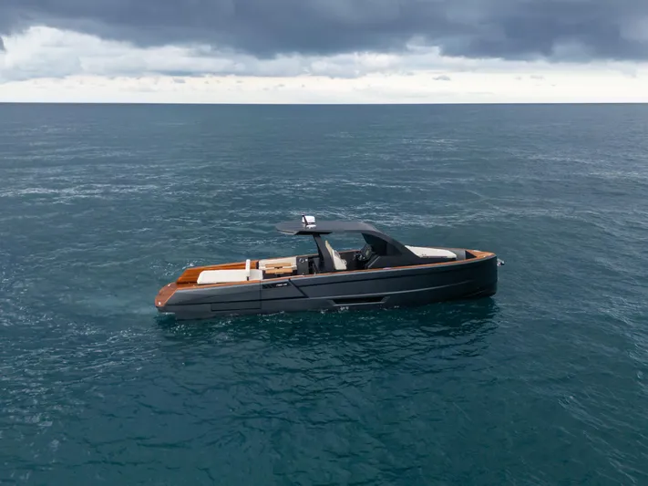 Maxim Yachts | Max43 Comfort Yacht Photos Pics 2025 Maxim Yachts 43 sailing on calm ocean under cloudy sky.