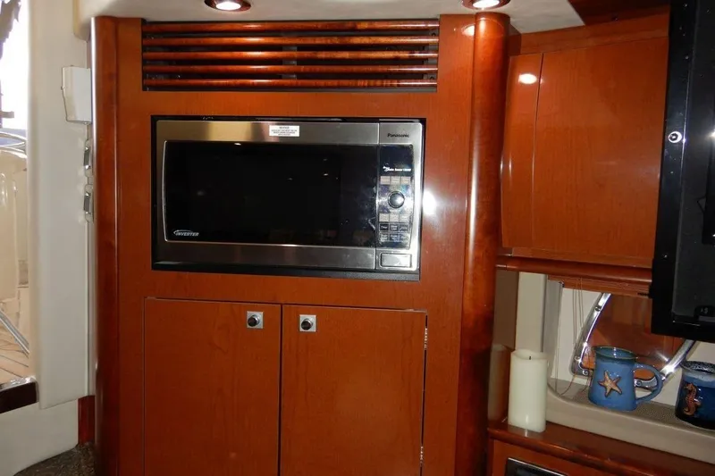  Yacht Photos Pics 2008 Sea Ray 40 Sundancer interior with microwave and wooden cabinetry.