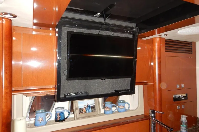  Yacht Photos Pics Interior of 2008 Sea Ray 40 Sundancer with mounted TV and wooden cabinetry.