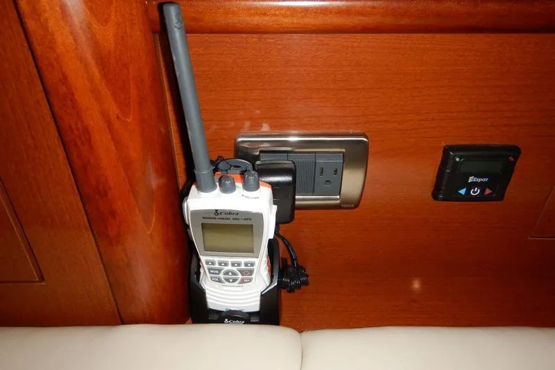  Yacht Photos Pics Handheld marine radio charging on a 2008 Sea Ray 40 Sundancer yacht's wooden interior.