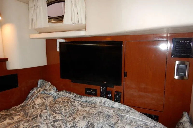  Yacht Photos Pics Interior cabin of 2008 Sea Ray 40 Sundancer with TV and patterned bedding.