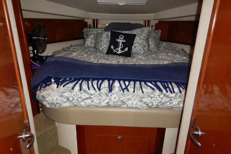  Yacht Photos Pics Luxurious cabin interior of 2008 Sea Ray 40 Sundancer yacht with nautical-themed bedding.