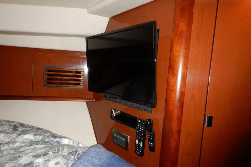  Yacht Photos Pics Interior of 2008 Sea Ray 40 Sundancer with mounted TV and wooden paneling.
