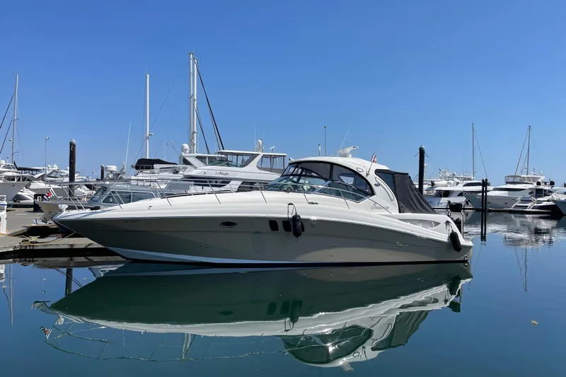  Yacht Photos Pics 2008 Sea Ray 40 Sundancer yacht docked in a marina, reflecting on calm water.