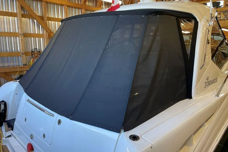  Yacht Photos Pics 2008 Sea Ray 40 Sundancer yacht with black canvas cover in a wooden boathouse.