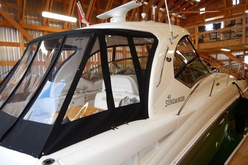  Yacht Photos Pics 2008 Sea Ray 40 Sundancer yacht in a wooden boathouse, featuring sleek design and enclosed cockpit.