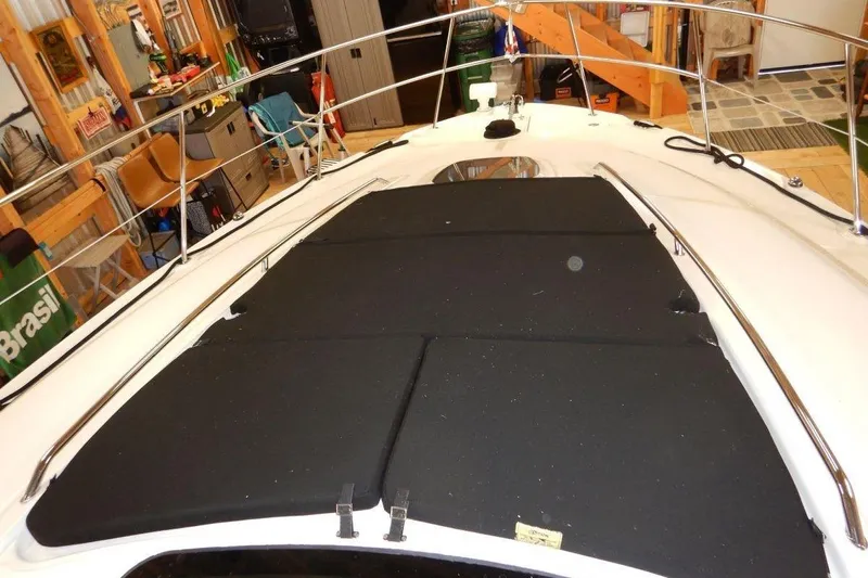  Yacht Photos Pics 2008 Sea Ray 40 Sundancer boat deck with black sun pads in a garage setting.