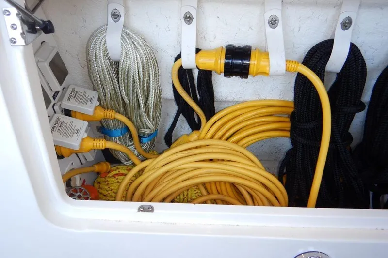  Yacht Photos Pics Storage compartment with coiled ropes and yellow power cables on a 2008 Sea Ray 40 Sundancer.