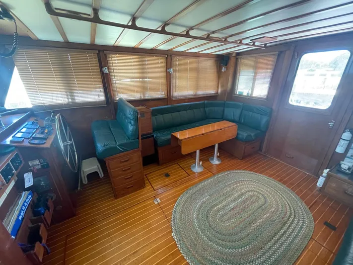 September Yacht Photos Pics 1979 Jarvis Newman Trawler interior with wooden finish and green seating.
