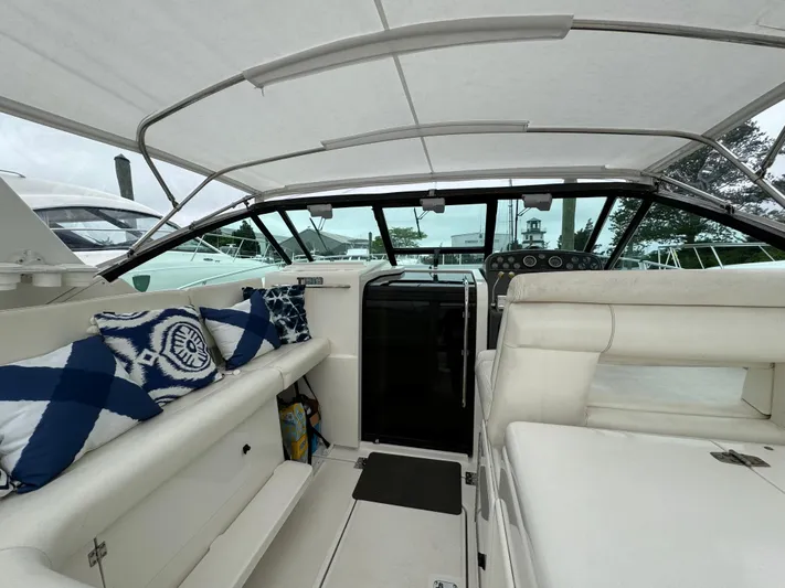Vixen Yacht Photos Pics 2002 Tiara Yachts 3500 Express interior with white seating and nautical-themed pillows.